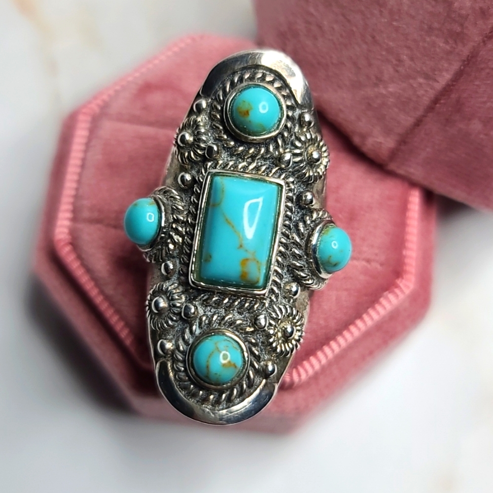 Sterling silver turquoise oval ring embellished with stones and details